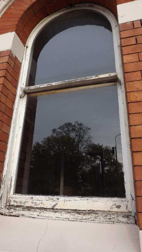 Warped and rotten old sash window