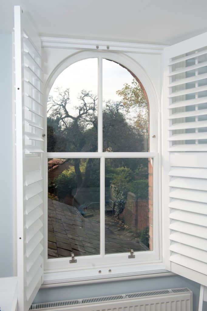 curved sash window with shutters