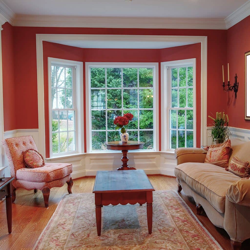 interior shot of red living room with sash bay window